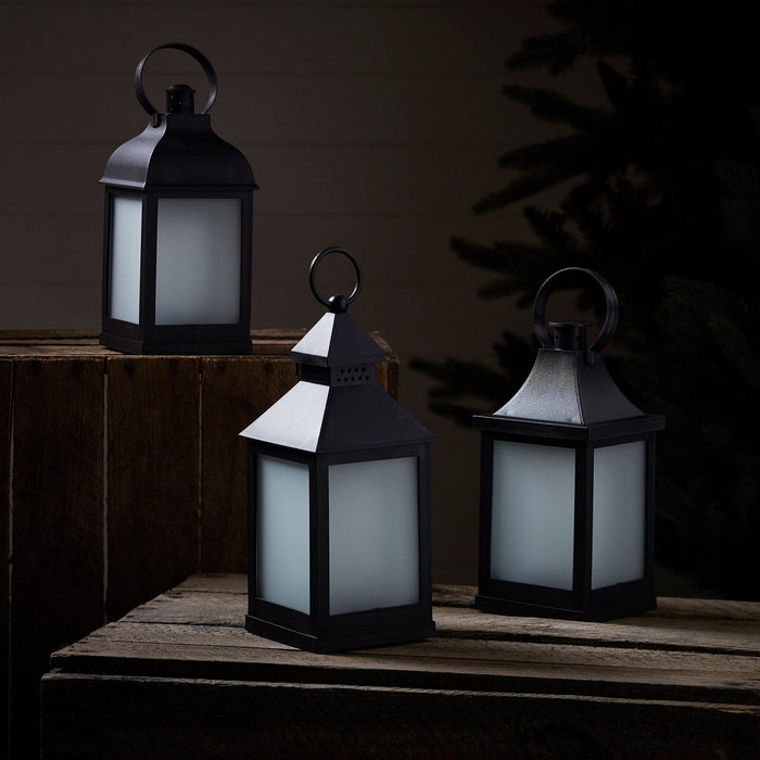 LA19013_3-Flame-Effect-Garden-Lanterns-In-A-Night-Time-Setting-Off.jpg