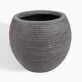 A round, dark gray textured planter pot with horizontal grooved lines and a speckled finish, shown on a clean white background.