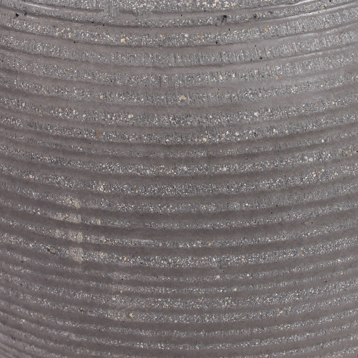 Close-up of a ribbed gray textured ficonstone surface with horizontal grooves and fine speckled material.