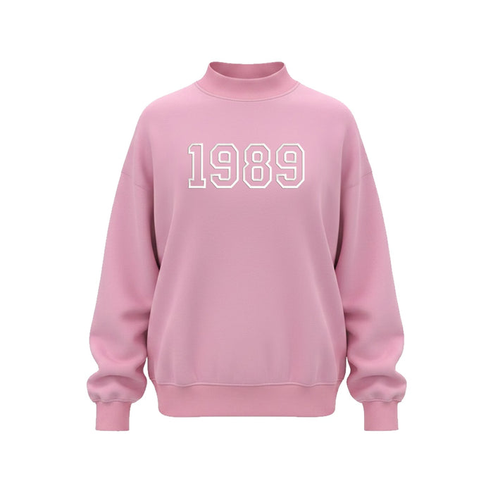 Pink mock neck sweatshirt with white 1989 embroidery on chest
