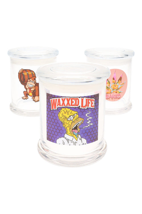 Three extra-large clear glass apothecary jars with assorted decals—“Waxxed Life” honeycomb head, barrel-tossing ape, pink donut splash—on white background