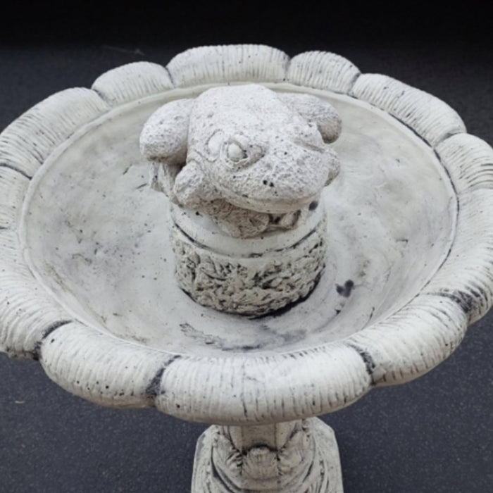 concrete frog bird bath with a natural grey finish and detailed sculpted frog ornament