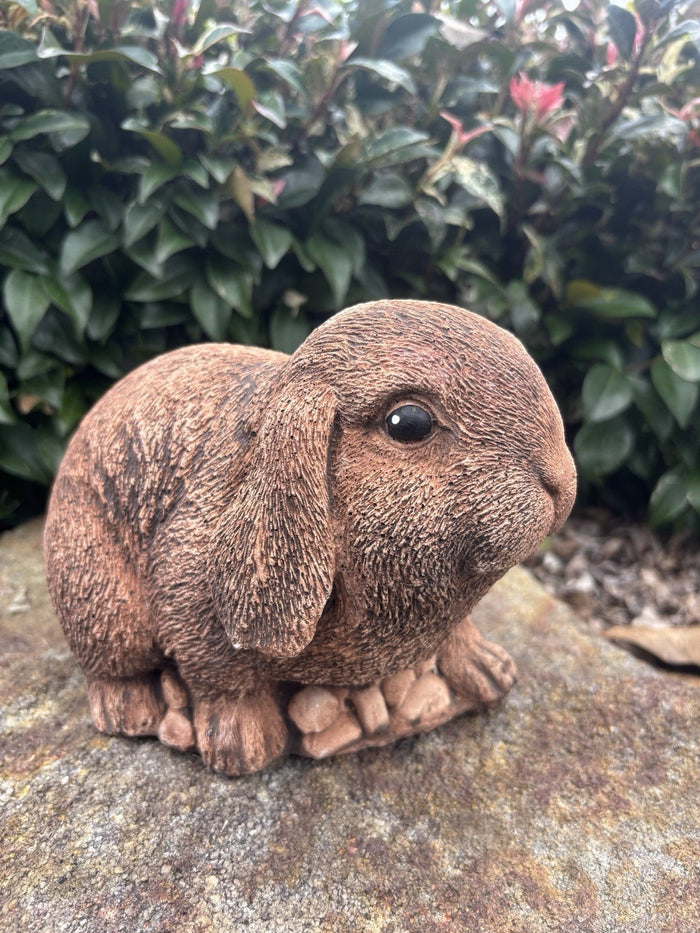 22nice4me Garden Statues handcrafted brown concrete Mini Lop rabbit garden ornament sitting on a stone surface