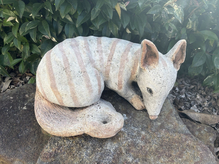 22nice4me Garden Statues handcrafted concrete numbat ornament with grey and brown striped markings in a garden setting