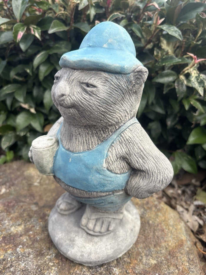 22nice4me Garden Statues concrete wombat wearing a blue hat and overalls holding a beer can in a garden setting