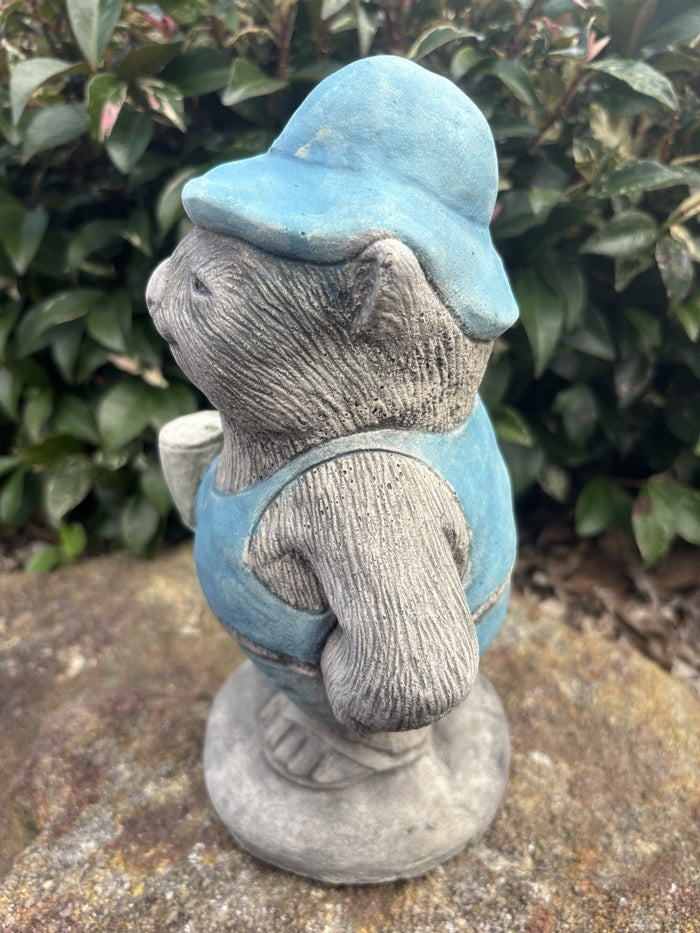 22nice4me Garden Statues concrete wombat wearing a blue hat and overalls holding a beer can in a garden setting