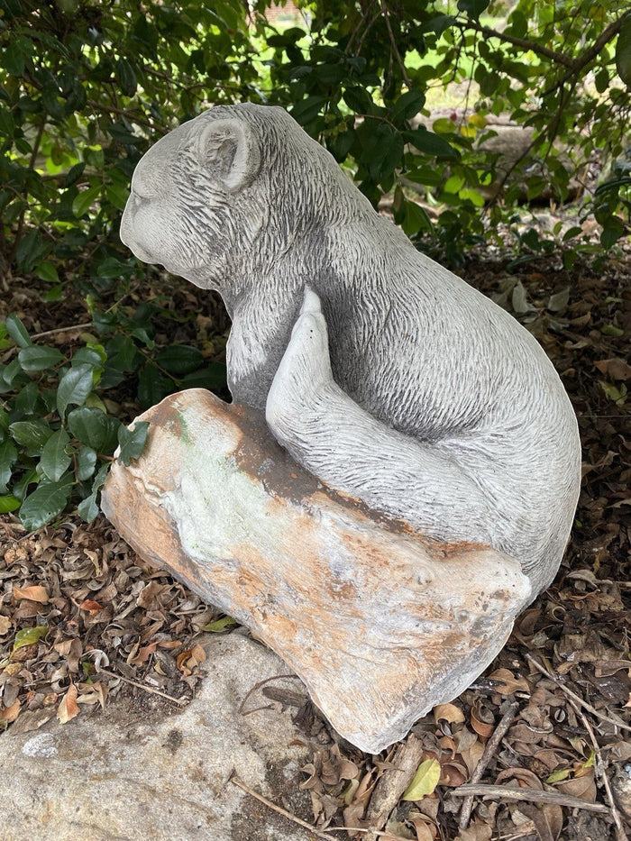 22nice4me Garden Statues concrete wombat figurine scratching itself next to a log in a garden setting