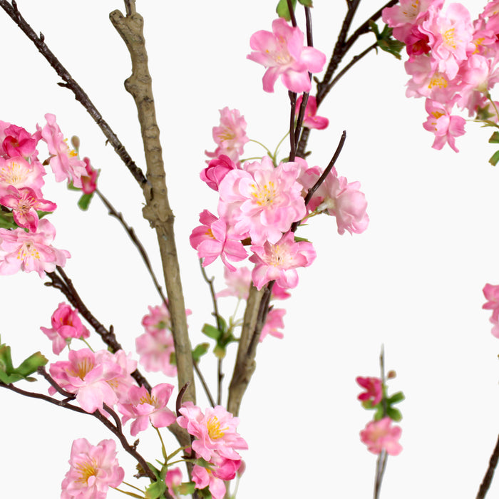 Artificial pink blossom branches on a white background