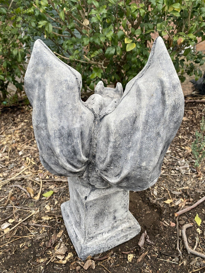22nice4me Garden Statues concrete gargoyle figurine with antique rustic finish on a pedestal in a garden setting