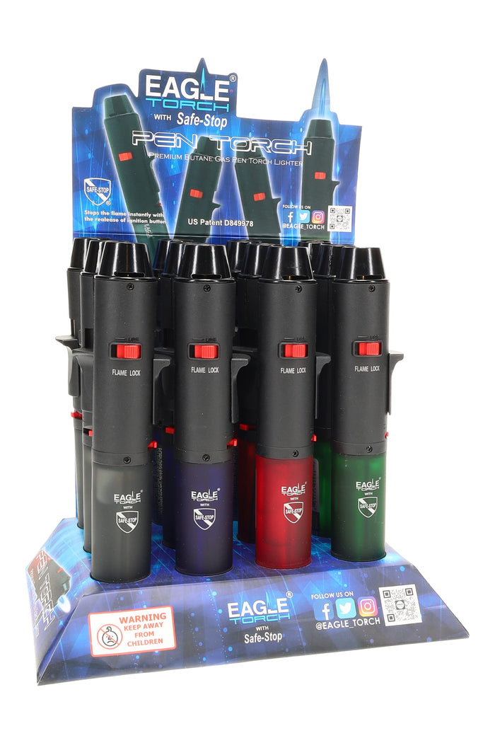 12-piece counter display of Eagle pen torch lighters in assorted red, green, and black with Safe-Stop branding and flame-lock detail, jet torch style.
