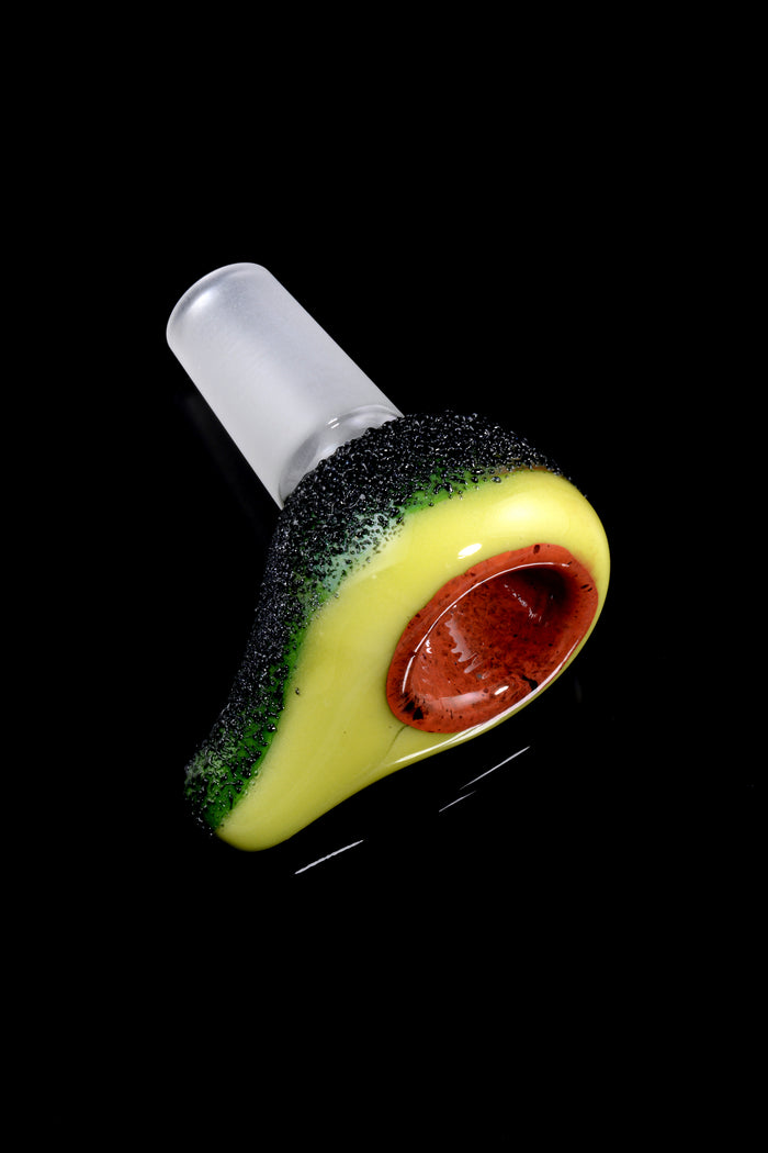 Avocado-themed glass bowl for bongs with 14.5 mm male joint, textured dark rind and pit-shaped herb chamber on green body.