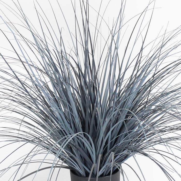 Faux potted plant with long, thin leaves on a white background