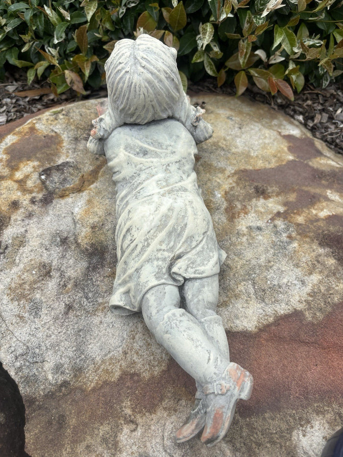 22nice4me Garden Statues concrete girl reading a book ornament lying on a stone surface in a garden setting