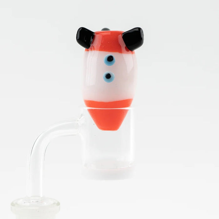 Rocket bubble cap seated on a flat-top quartz banger, tip inside the bucket to steer airflow during dabs.