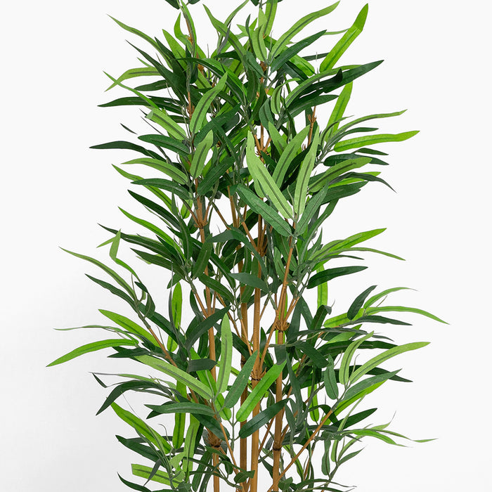 Artificial bamboo plant with green leaves on a white background