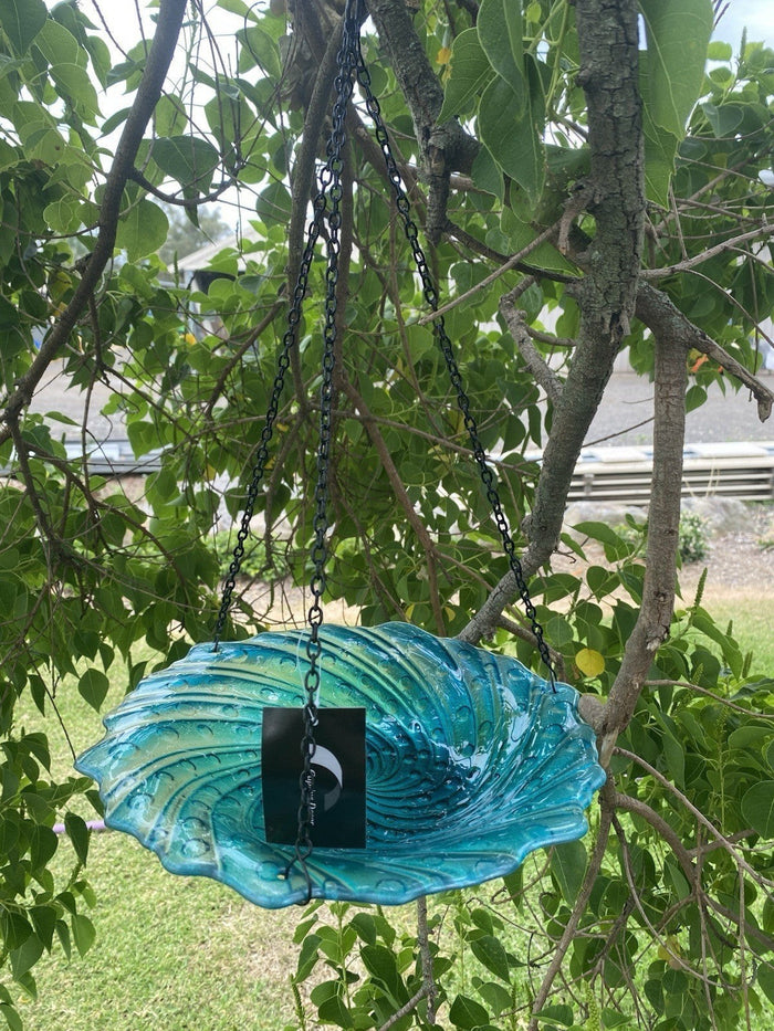 22nice4me Garden Statues hanging glass bird feeder in teal with a black metal chain suspended from a tree branch.