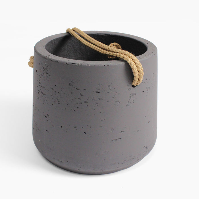 Concrete planter with a rope handle on a white background