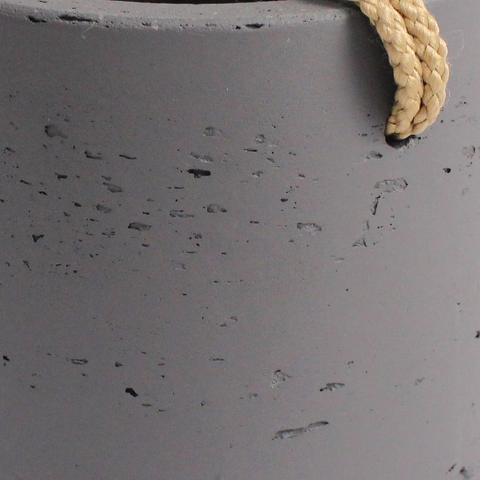 Close-up of a textured gray surface with a rope corner