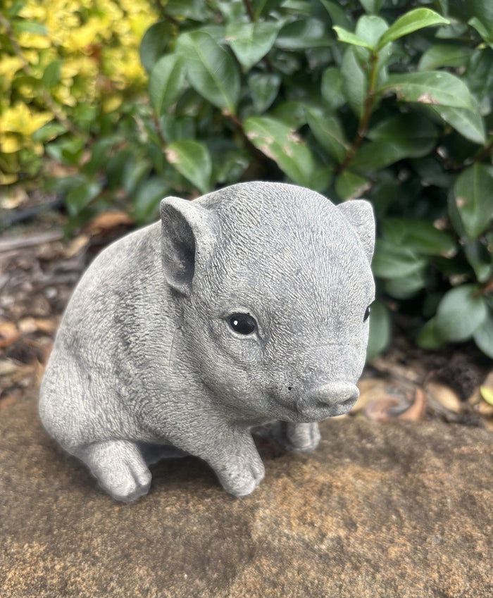 22nice4me Garden Statues hand-painted concrete piglet ornament sitting on a stone surface in a garden setting