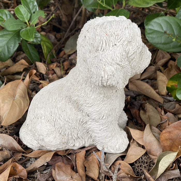 Side view of concrete maltese terrier garden statue outdoor dog ornament