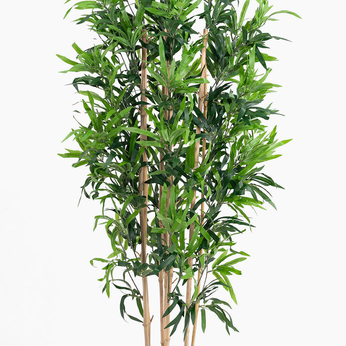 Artificial bamboo plant with green leaves on a white background