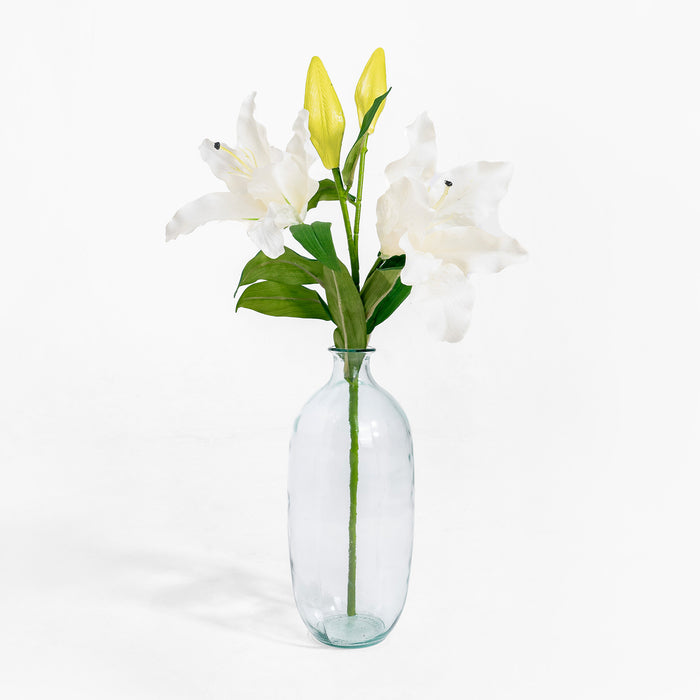 Clear glass vase with white and yellow flowers on a white background