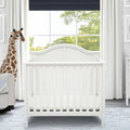 Delta Children Bianca White (130) Mini Convertible Baby Crib with Mattress and 2 Sheets Twin Bed