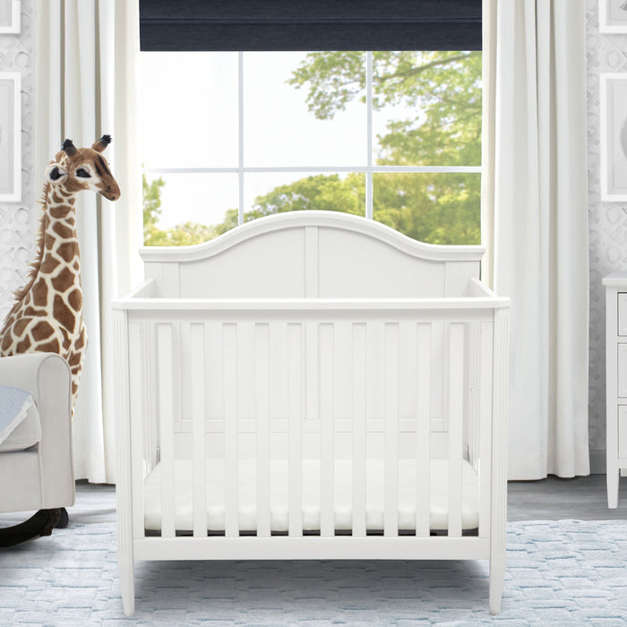 Delta Children Bianca White (130) Mini Convertible Baby Crib with Mattress and 2 Sheets Twin Bed
