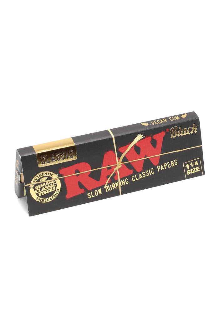 RAW Black 1¼ size rolling papers single booklet in matte black wrapper with gold accents and band; classic slow-burning unbleached paper.