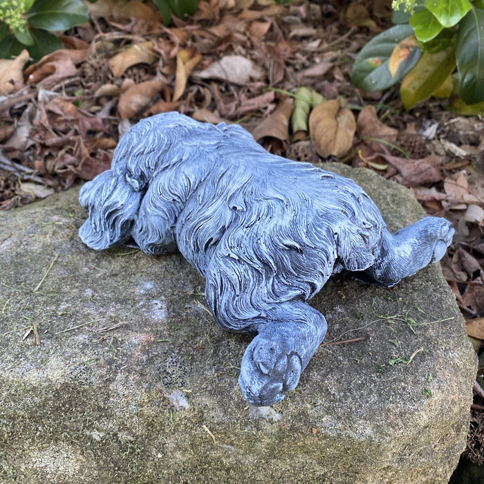 back view of a Concrete sleeping cavoodle garden statue outdoor cement dog ornament