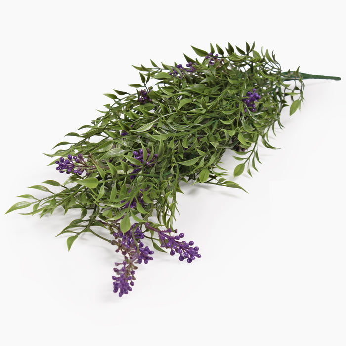 Artificial green leafy branch with clusters of small purple flowers, photographed on a plain white background.