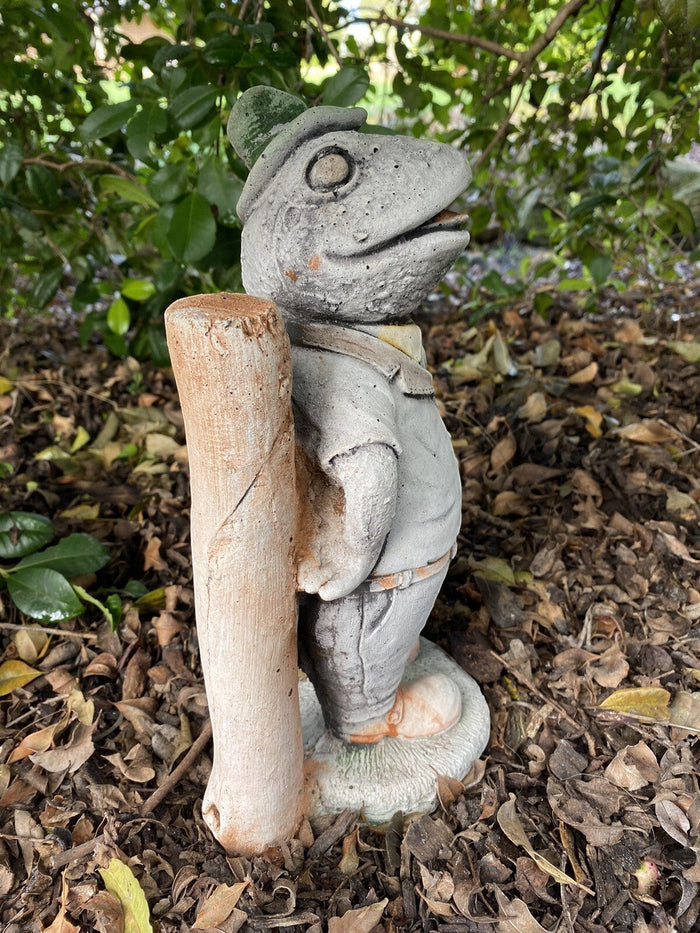 22nice4me Garden Statues Willow frog Mr Fisher concrete statue standing by a wooden post in a garden setting