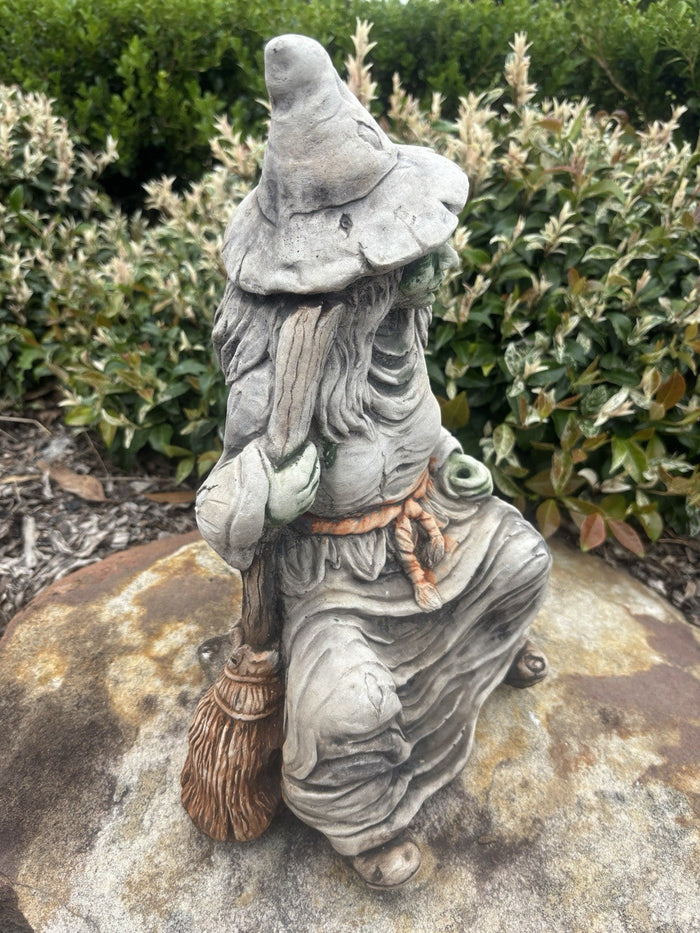 22nice4me Garden Statues hand-painted concrete witch statue sitting with a broomstick in a garden setting