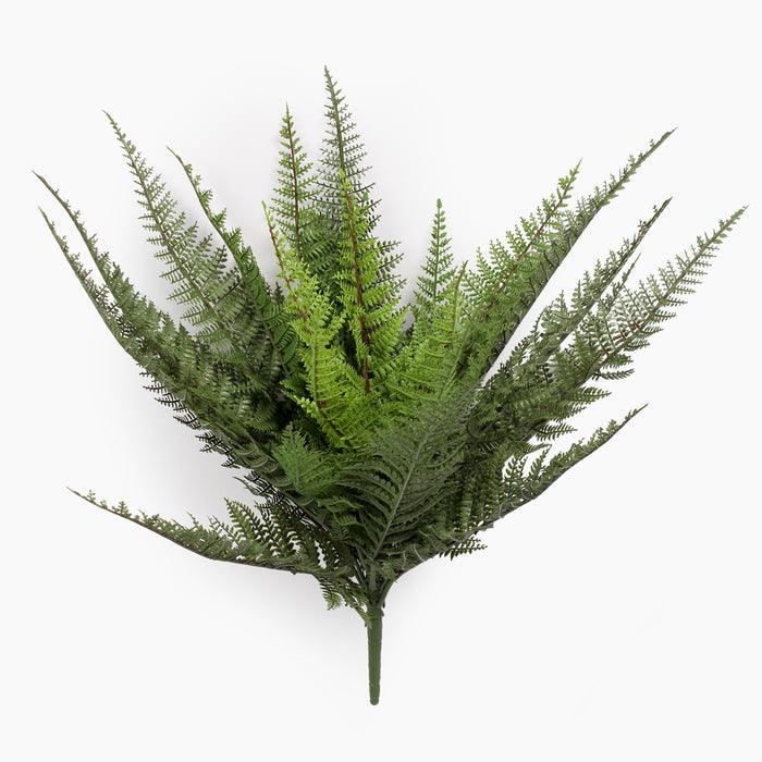 Artificial fern plant on a spike from the side on a white background