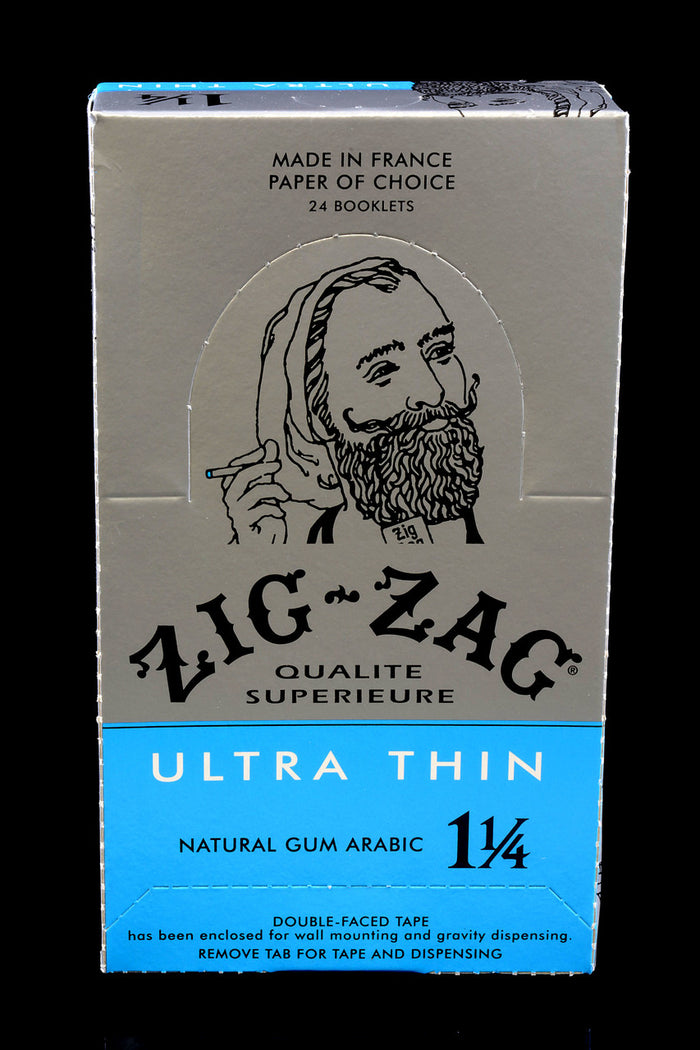 Closed 1¼ Zig-Zag Ultra Thin display case labeled Natural Gum Arabic; 24 booklets in silver and blue.
